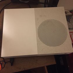 xbox one s and a controller with games