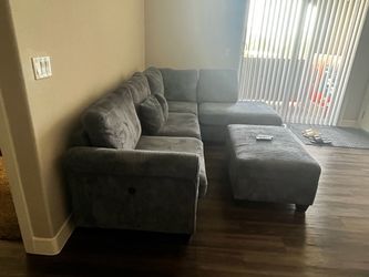 Grey sectional couch with ottoman