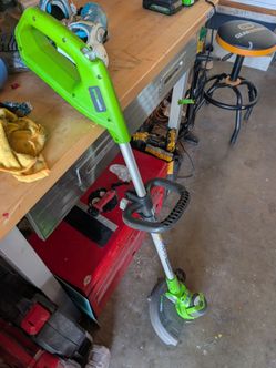 Greenworks weedwacker, battery, charger and wire.