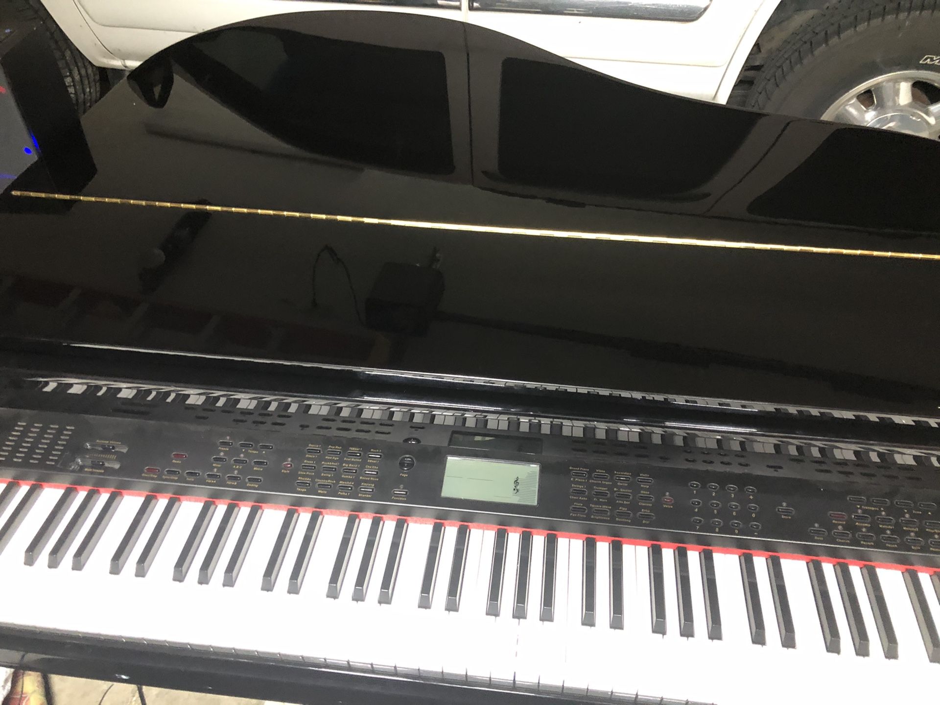 Electric baby grand piano contains sound bar and sub woofer