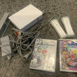Nintendo Wii Console with Games  Includes Wii console, two controllers, and 2 games: Mario Kart and Mario Party 9