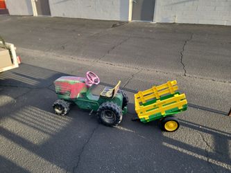 Vintage pedal tractor with wagon.