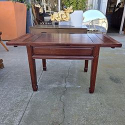 Simpli Home Artisan transitional rectangular side table made of solid wood, with a reddish-brown finish.
