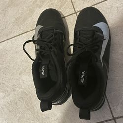 The item shown is a pair of Nike Alpha Menace 4 Shark Football Cleats in black. 