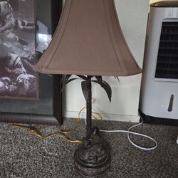 Brass Monkey Sitting Under A Tree Lamp