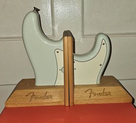 Fender Stratocaster Body Bookends featuring a light blue finish.
Modeled after Fender's legendary solidbody electric guitar, this desktop bookend brin