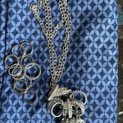 An elegant necklace with rings and rhinestones, and a set of 10 rings