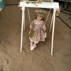 Porcelain Doll On Swing