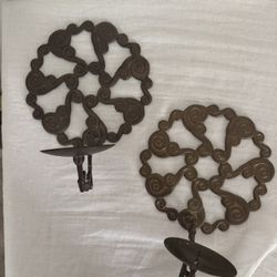 A pair of brass iron wall mount candle holders