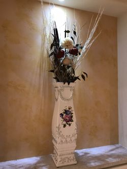 Ceramic vase with fake flowers arrangement