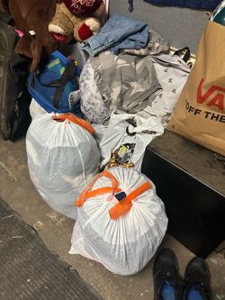 bags of nice clothes shoes and toys