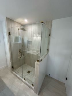 Frameless Glass Shower Enclosure with Gold Hardware