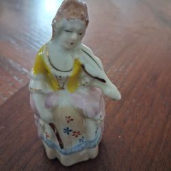 vintage porcelain figurine of a woman playing the violin
