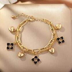 Four leaf and hearts gold plated doubled layered bracelet.