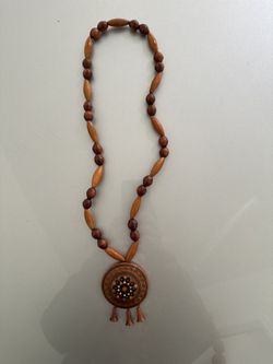Handmade wooden beaded necklace with a carved pendant