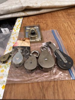 Various Sizes Of Pulleys And Combination Lock 