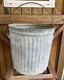 Large galvanized bucket with bail handle.