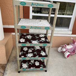 Plastic shelf with 5 compartments, some cracks but functional. Height 59 inches, length 26 inches, and width 16 inches