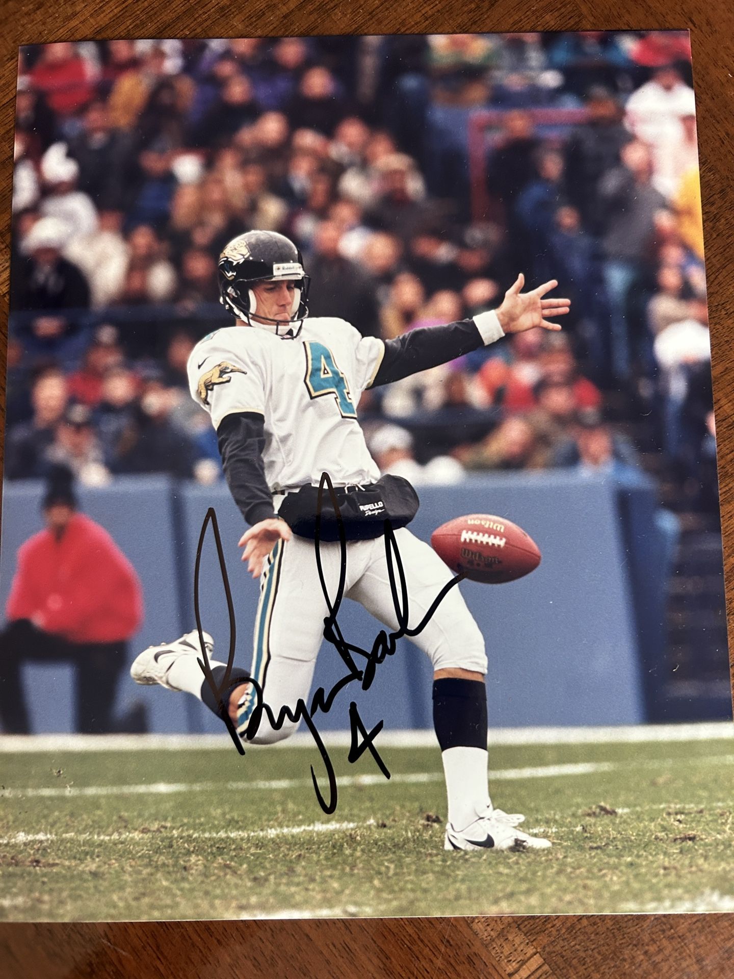 Autographed photo signed in black marker by football player number four color 8” x 10”