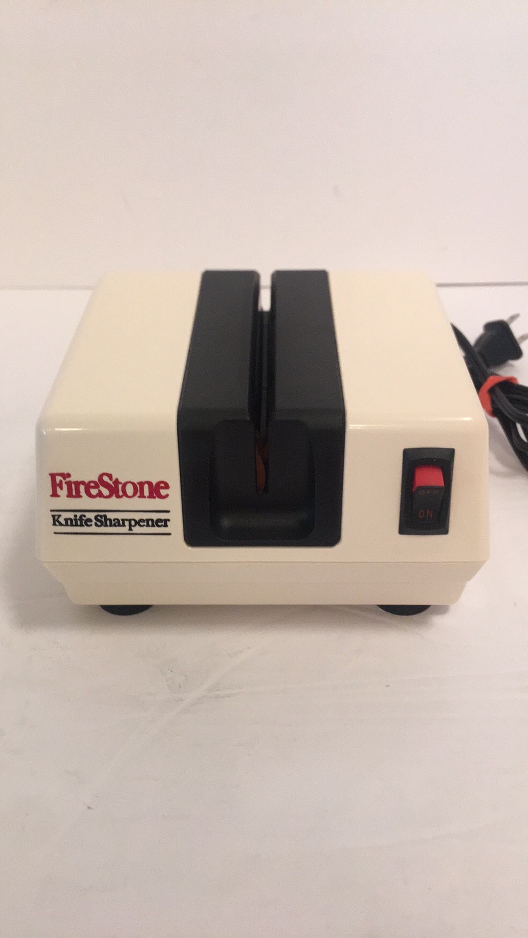 Firestone Electric Knife Sharpener white plastic case model # 1902, 5 3/4”x 4 3/4”x 3”. Tested and working great. .62AMP 120 VAC 60HZ