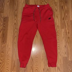 red nike tech pants size M