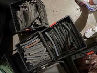 3 crates filled with short lengths of black rubber tubing