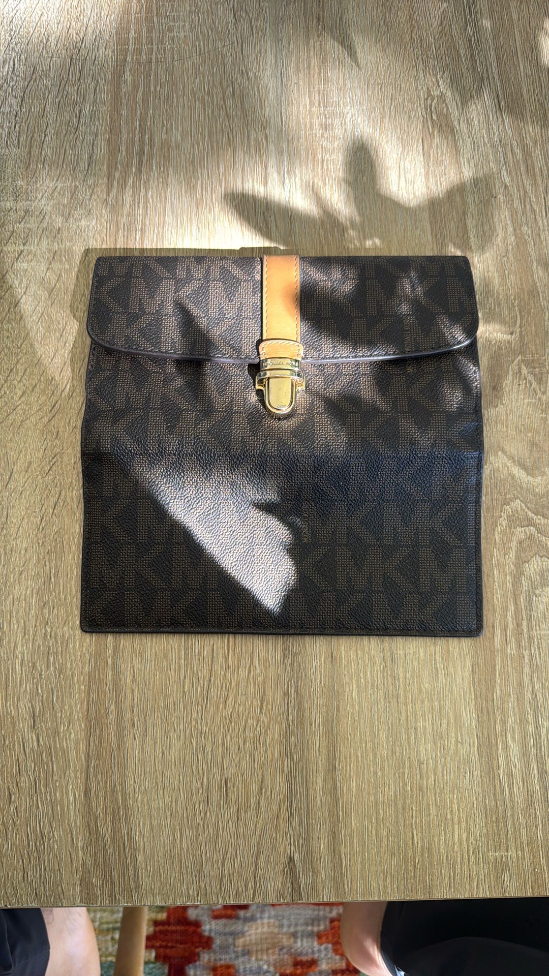 Michael Kors wallet — specifically a Michael Kors monogram zip or flap wallet.