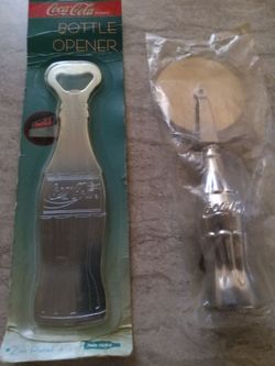 Vintage coca cola bottle opener and bottle Pizza cutter both new perfect never opened sealed located in palm springs ca