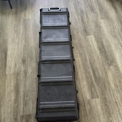 Rigid plastic rifle case with wheels.