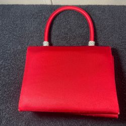 Red satin handbag with braided strap