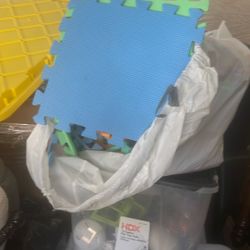Two Bags Full Of Foam Padding For Workout On Floor
