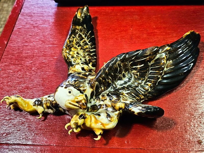 Realistic porcelain 3D hanging eagle figure.