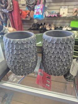 black scalloped planters, sometimes referred to as fish scale patterned pots.