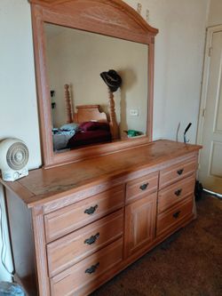 Solid wood dresser with mirror and matching amoire.