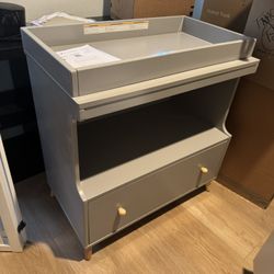 Delta convertible changing table with drawers