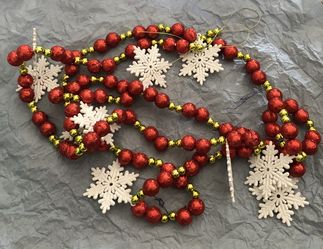 Red and Yellow Garland With White Snowflakes 