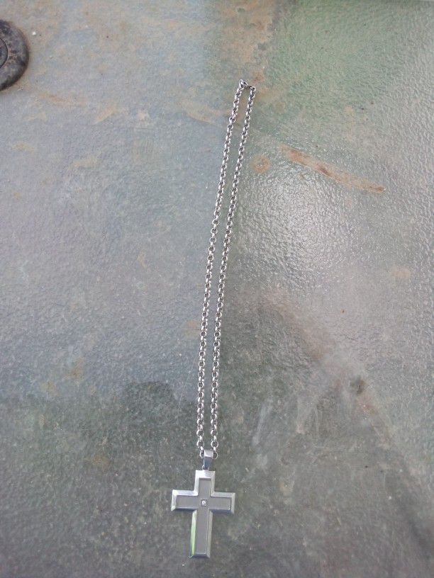 A Sterling Silver Chain With A Cross With A Little Diamond On It