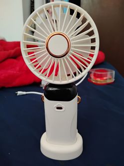 portable handheld mini fan with an LED digital display and RGB color-changing light feature.