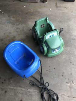 Baby swings a standard and a hJohn Deere tractor