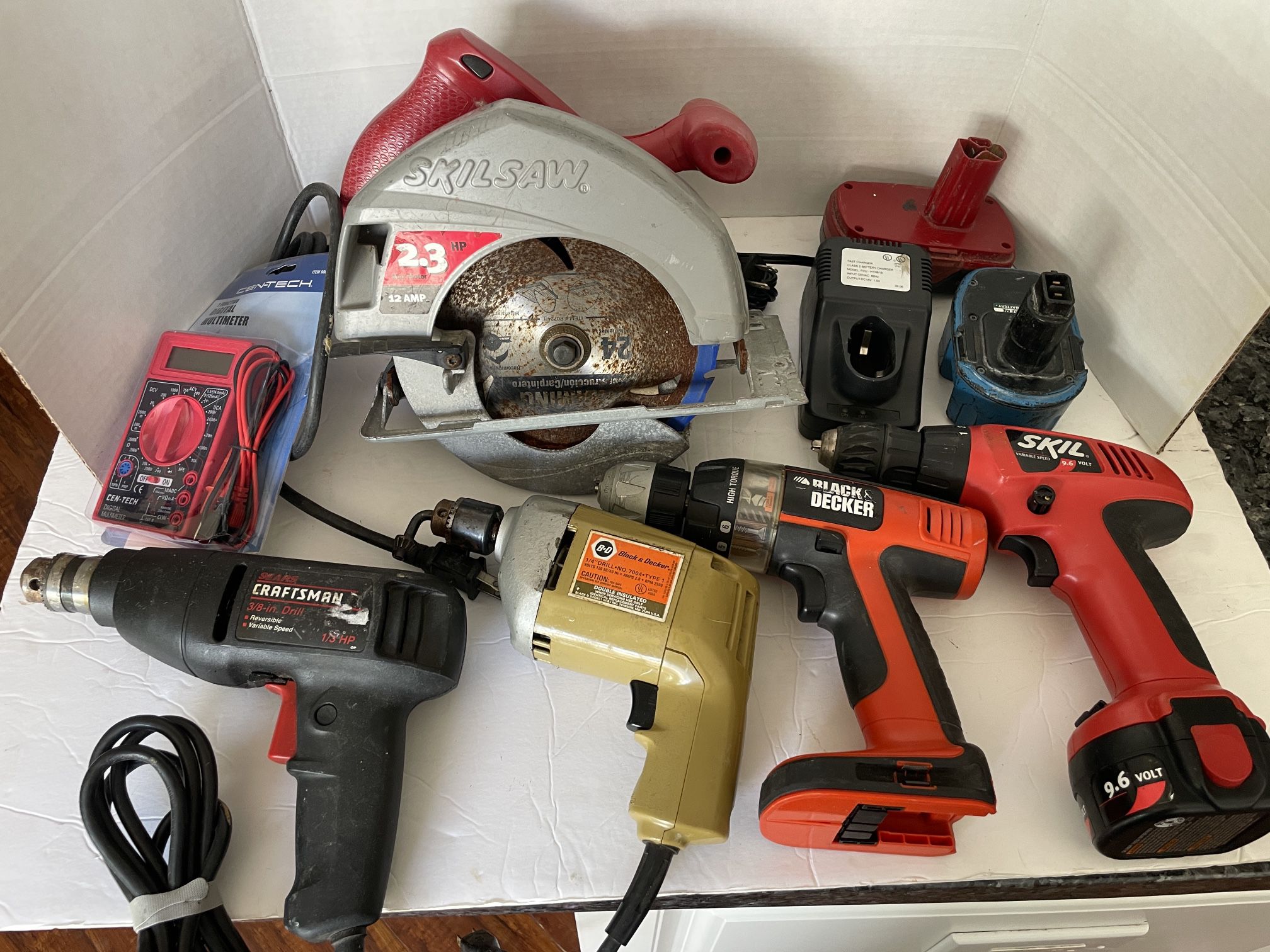 Bin Of Power Tools And Chargers 
