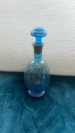 Blue glass decanter with silver floral overlay and silver accents.