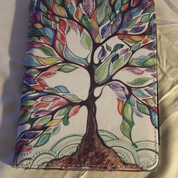 Fintie Stand Case for an Amazon Kindle e-reader, featuring a colorful tree design on the interior.   Ready to pickup.