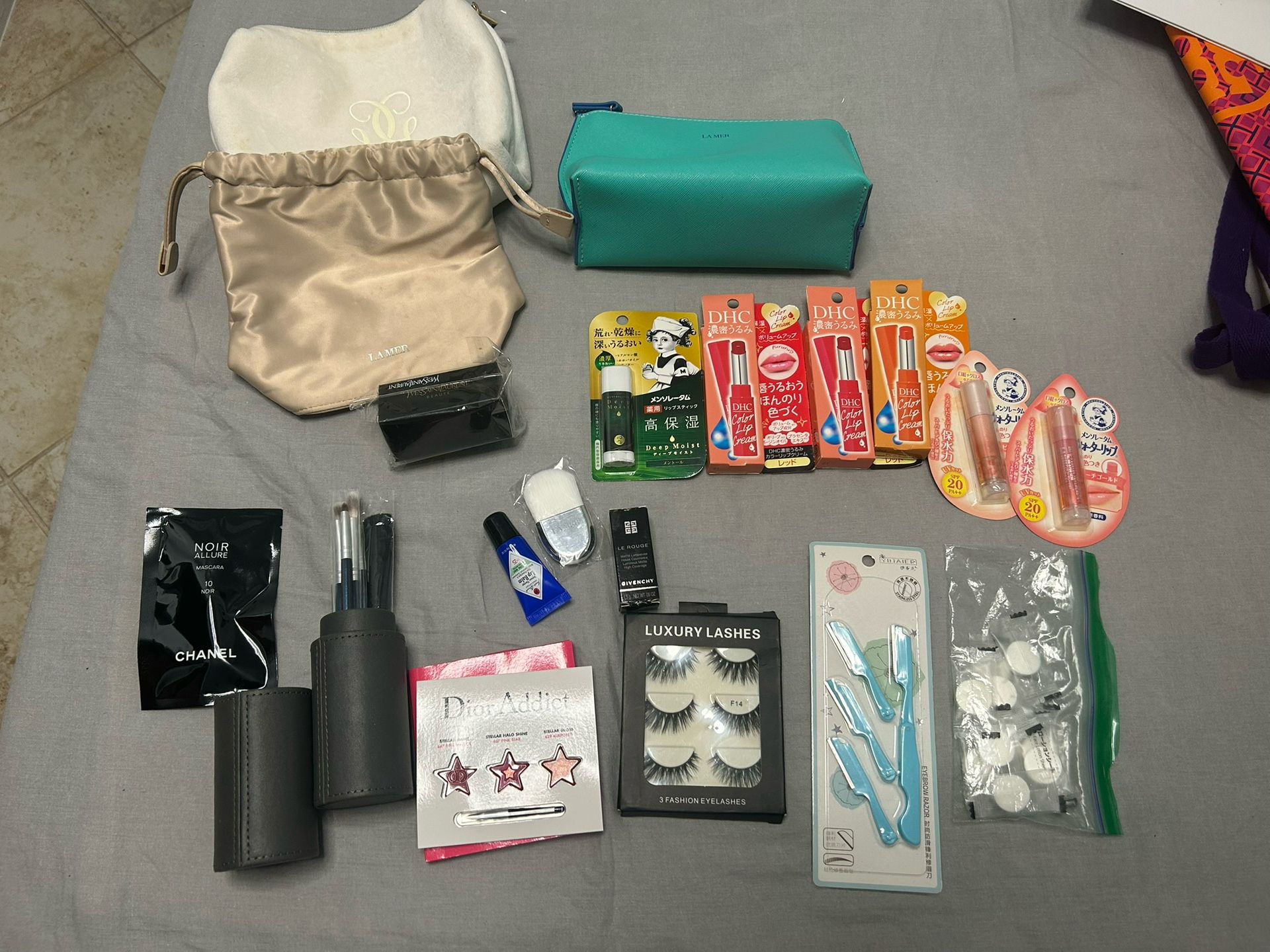 Cosmetics, some makeup brushes, and other accessories.