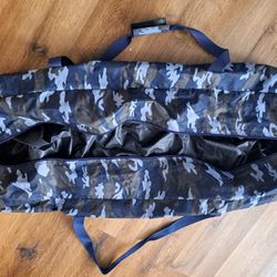 The XL Zippered Duffel Bag in blue camouflage is a water-resistant travel bag designed for men. Made from a combination of polyester and canvas, this 
