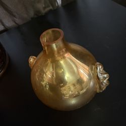 Vintage of marigold carnival glass, likely a vase or a bowl, known for its iridescent sheen