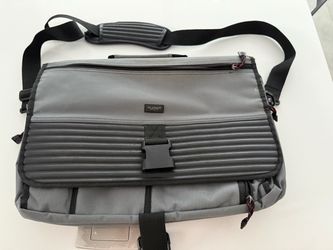 The U.S. Luggage Gray/Black Nylon 15in Laptop Messenger Shoulder Bag is a stylish and practical accessory for carrying your laptop on-the-go. Made of 