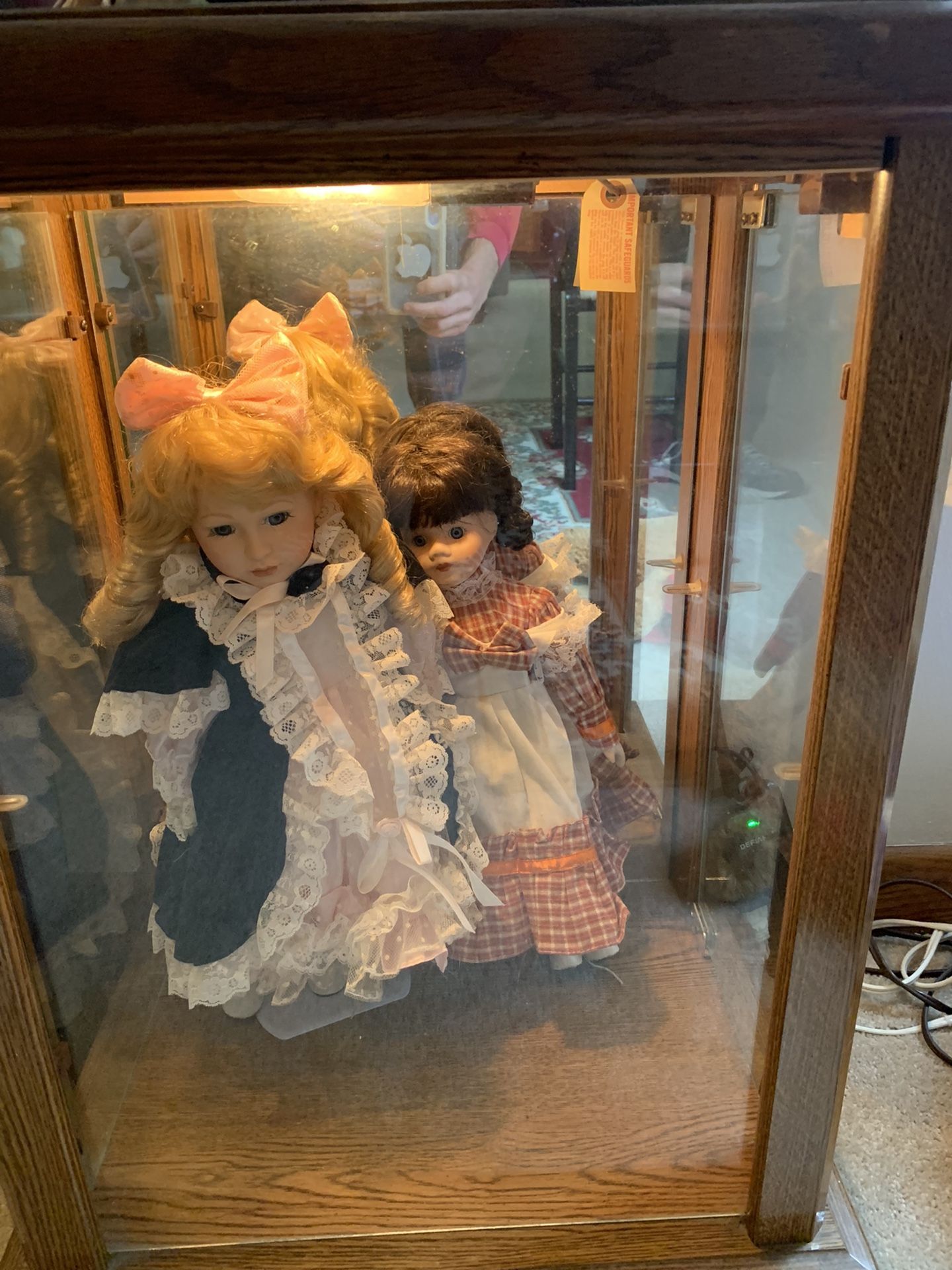 Shirley Temple dolls and Amish dolls and both cabinet