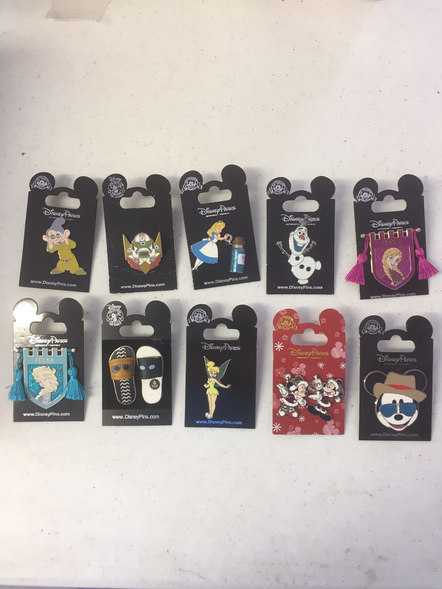 10 assorted DISNEY TRADING PINS.