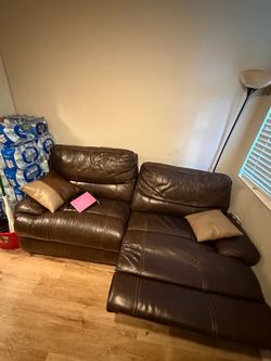 Brown leather love seat