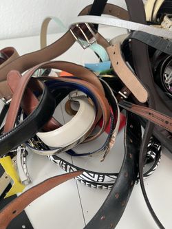 Large bundle of assorted women’s belts in various styles, colors, and materials.